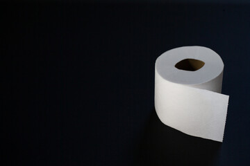 Toilet paper photographed on black background
