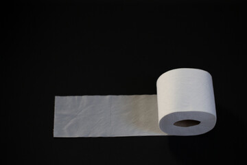 Toilet paper photographed on black background