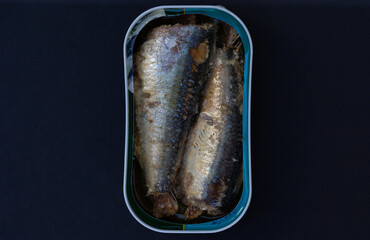 Canned sardines, phtographed on black background