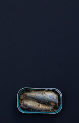 Canned sardines, phtographed on black background