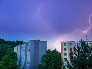 Lightning strike over a residential house on the outskirts of the city - long exposure at night
