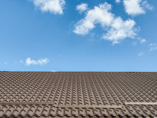 the tiled roof of a house and a clear sky