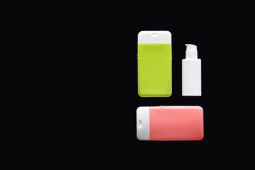 Flat lay spa composition with skin care products on black background.