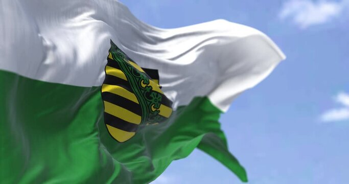 Seamless loop in slow motion with the flag of Saxony waving in the wind on a clear day