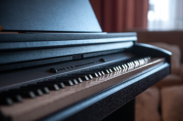 Close-up, keys of an electronic piano on a blurred background.