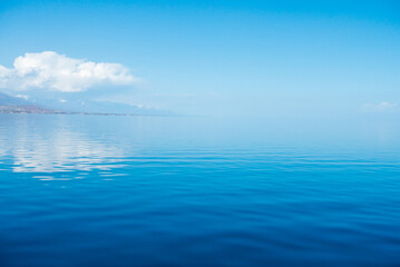 Blue sea water. Water and sky. Natural ocean surface background on the sky.