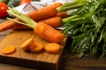 Fresh and sweet carrots on a brown table.Sliced carrot slices.Healthy vegan food.Fresh organic carrots.Vegetables. Healthy food.Space for copy.