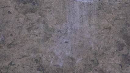 Rain water pours onto the concrete base. Shower. Falling drops. The season is summer. Tropical climate. Precipitation in the form of rain. Close-up. - Powered by Adobe