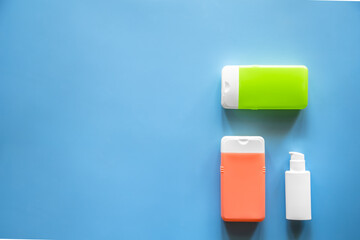 Flat lay spa composition with skin care products on blue background.