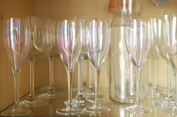 classic tainbow champagne glasses on shelf in dresser - closeup