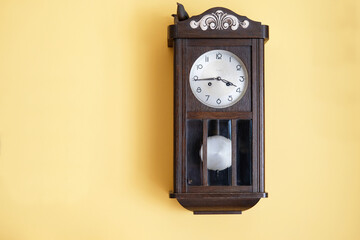 antique grandfather's clock on yellow wall