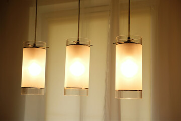 three glowing lights lit over table