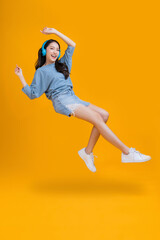 happiness carefree asian young female woman teen wearing headphone smartphone listen music joyful fun moving moment ,teen wear casaul cloth singing move while laugh smile trendy lifestyle studio shot