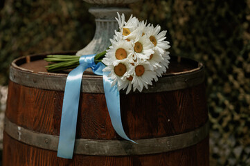 Ukrainian bride's wedding bouquet of white daisies tied with a blue ribbon