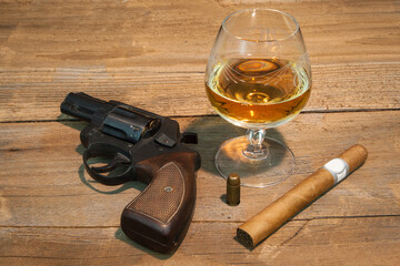 Symbols of Mafia Power. Revolver, cognac, cigar and a projectile, personal paraphernalia of a mafia...
