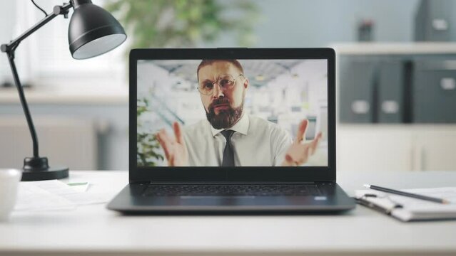 Modern wireless laptop with caucasian bearded man in suit talking and gesturing during video conference. Concept of people, technology and online conversation.