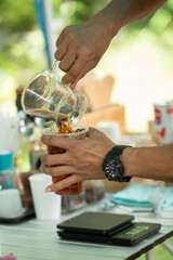 close up barista prepare an iced americano coffee
