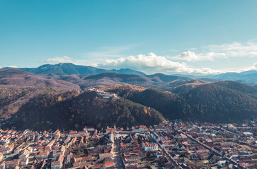 Aerial view of Rasnov, Romania shows that the buildings are styled with medieval fortress architecture. Medieval fortification in Brasov