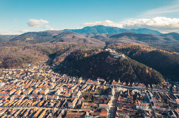 Aerial drone view of The Rasnov Fortress in Romania. Medieval fortress with Rasnov inscription on the top of the hill