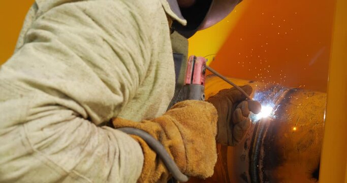 The Gasman Welds The Pipes At The Factory With A Welding Machine
