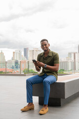 Portrait of handsome young black man outdoors in city