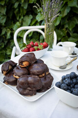 Delicious snack in the garden with fruit and puff pastries with chocolate. Sweets for tea or coffee time in the garden. Typical sweet from Morata de Tajuña (Spain)