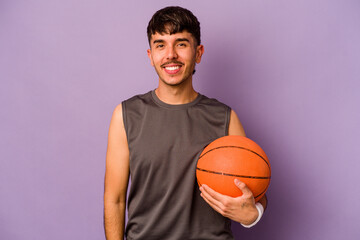 Young hispanic basketball player man isolated on purple background happy, smiling and cheerful.