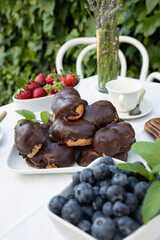 Delicious snack in the garden with fruit and puff pastries with chocolate. Sweets for tea or coffee time in the garden. Typical sweet from Morata de Tajuña (Spain)