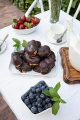 Delicious snack in the garden with fruit and puff pastries with chocolate. Sweets for tea or coffee time in the garden. Typical sweet from Morata de Tajuña (Spain)