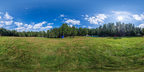 Fototapeta na wymiar Full seamless 360 degree HDRI spherical panorama on a large spacious green field, sunny weather in the forest, glade in the forest. VR content