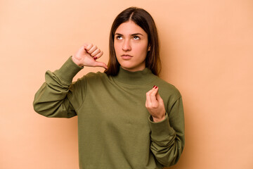 Young hispanic woman isolated on beige background showing that she has no money.