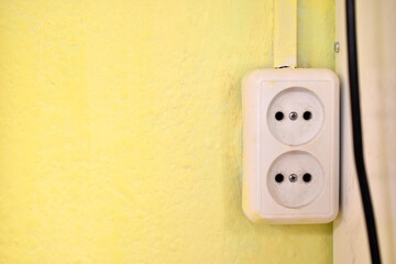 Electrical outlet on the yellow wall in the house