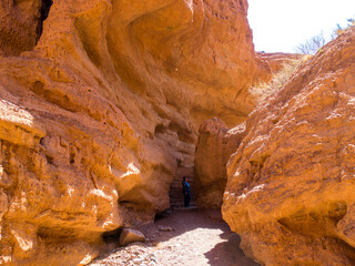 Red rocks and a passage between rocks. Clay canyons. Issyk-Kul region in Kyrgyzstan. Travel and tourism