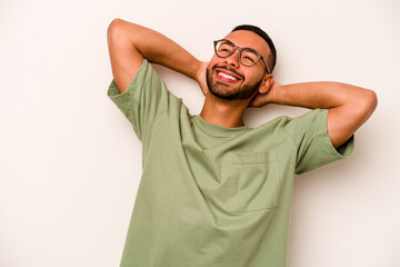 Young hispanic man isolated on white background feeling confident, with hands behind the head.