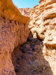 Red rocks and a passage between rocks. Clay canyons. Issyk-Kul region in Kyrgyzstan. Travel and tourism