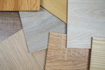 Obraz na płótnie Canvas Laminate background. Samples of laminate or parquet with a pattern and texture of wood for flooring and interior design.