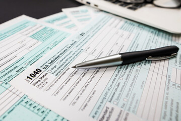 Close-up of tax form 1040 with a pen and a notebook