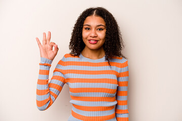 Young African American woman isolated on white background cheerful and confident showing ok gesture.