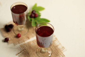 glasses of cherry brandy liqueur with ripe berries