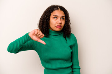 Young African American woman isolated on white background showing a dislike gesture, thumbs down. Disagreement concept.