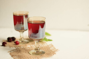 glasses of cherry brandy liqueur with ripe berries