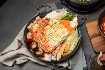 Korean instant noodle and Tteokbokki in spicy sauce, Rabokki - Korean food style with vegetables and seafood.
