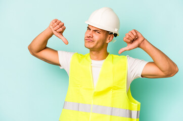 Young laborer caucasian man isolated on blue background feels proud and self confident, example to follow.
