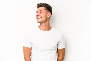 Young caucasian man isolated on white background relaxed and happy laughing, neck stretched showing...