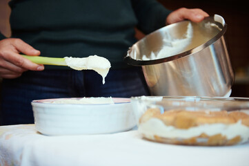 Close-up. Female chef pastry preparing cheese cream for cake at home. Culinary, homemade dessert