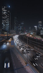Tel Aviv city at night. Speed highway and modern glass buildings