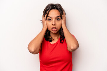 Young hispanic woman isolated on white background being shocked, she has remembered important meeting.