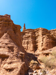 Red tales from clay. Issyk-Kul region in Kyrgyzstan. Beautiful mountain landscape. Tourism and...