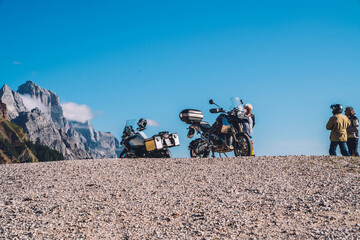 Obraz premium Parked motorcycle in a beautiful mountainous area with scenery view. Motorcycle summer trip in Europe