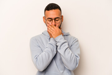 Young hispanic man isolated on white background suffers pain in throat due a virus or infection.